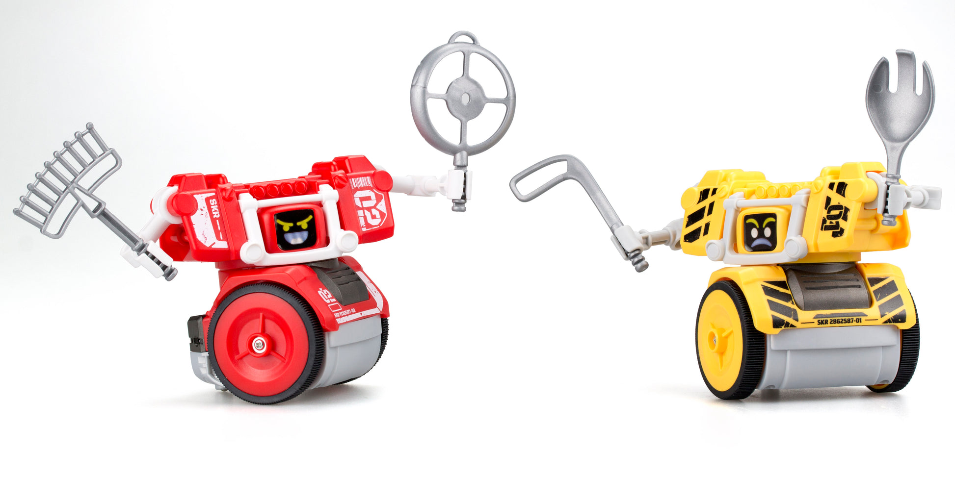 Two gesture-controlled battling robots on wheels facing each other—red robot with rake and steering wheel accessories on left, yellow robot with fork and hook a