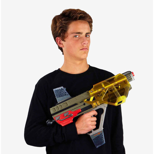 Xploderz Cobra Shield Firestorm Battler toy gun modeled by a child, featuring a yellow translucent chamber, red and gray body, and blue accents