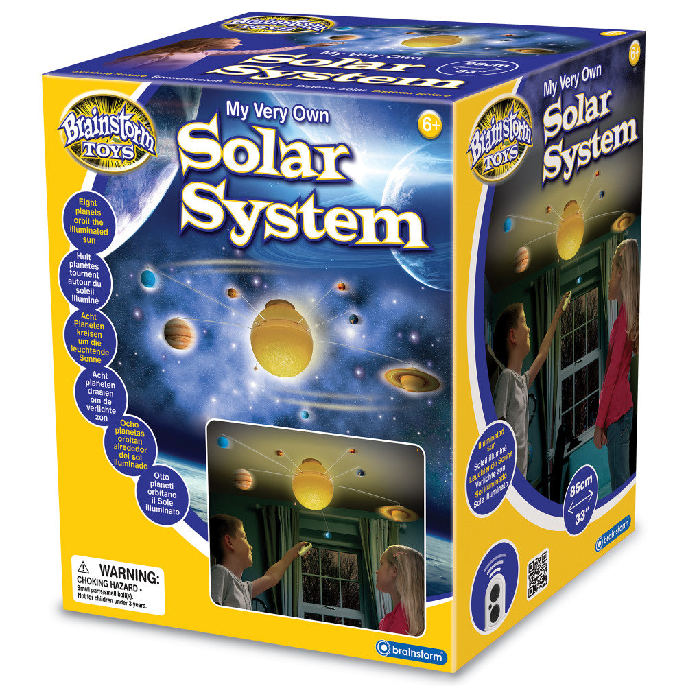 Brainstorm Toys My Very Own Solar System boxed kit with illuminated sun and eight planets on display, shown modeled by children in a bedroom setting