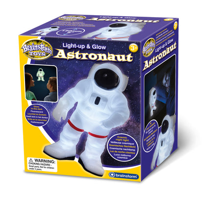 Brainstorm Toys Light-up & Glow Astronaut, white plush figure with purple gloves and red belt on starry purple packaging