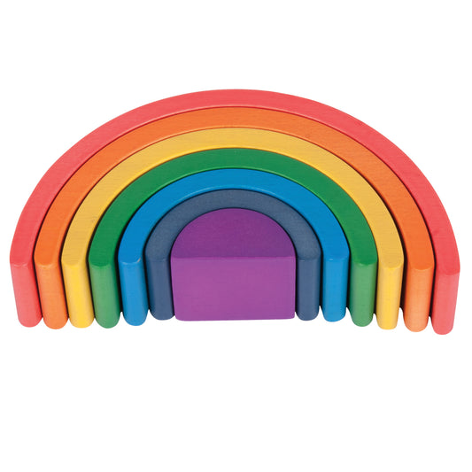 Seven colorful wooden arch blocks in rainbow order: red, orange, yellow, green, blue, gray, and purple, stacked to form a complete rainbow shape on plain backgr