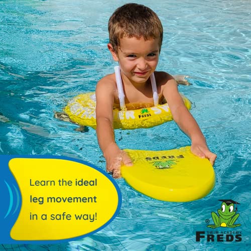 FREDS SWIM ACADEMY yellow kickboard with child learning leg movements in pool