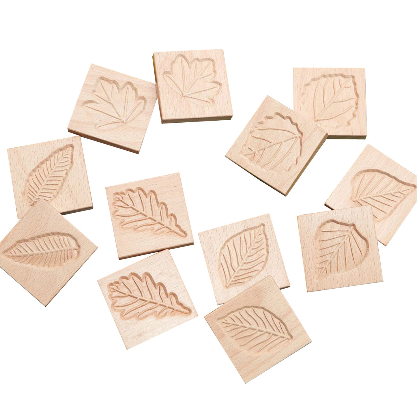 Twelve wooden tiles with carved leaf designs in various shapes, displayed on a white background