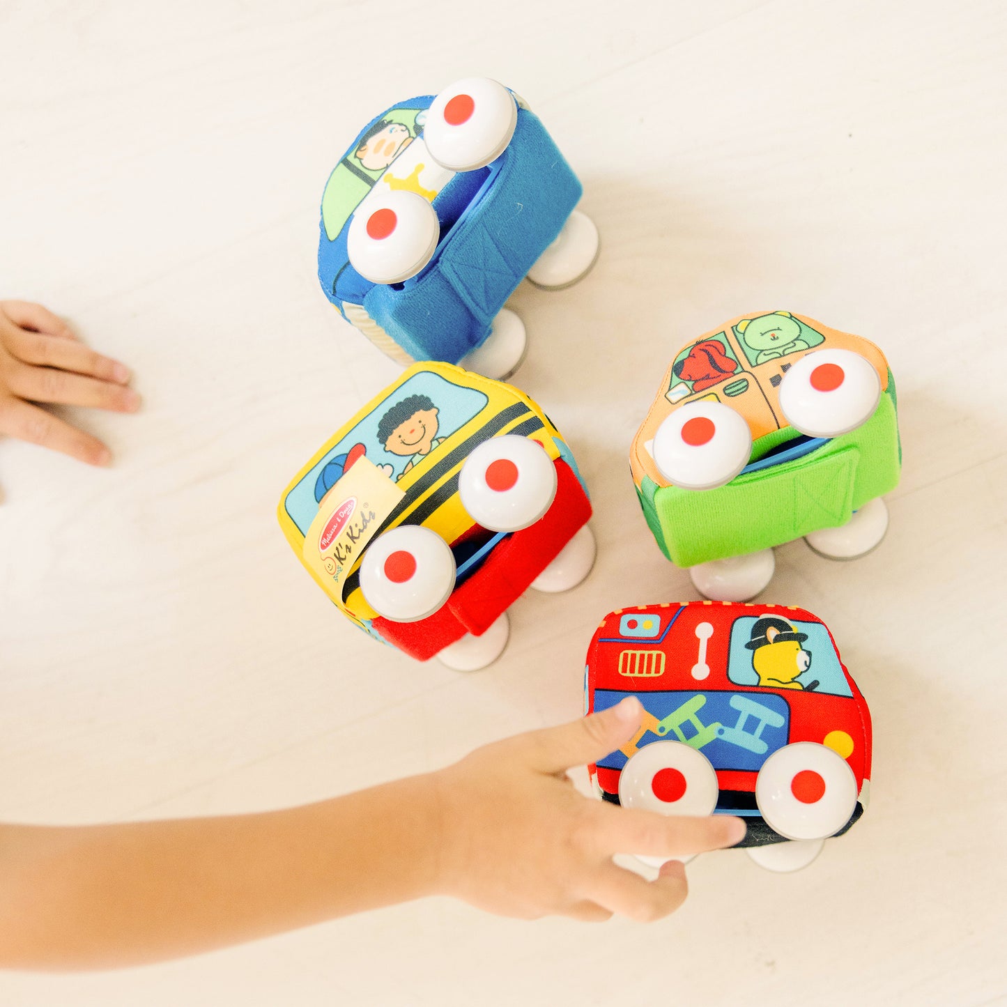 Melissa & Doug K's Kids Pull-Back Vehicle Set soft baby toys in blue, yellow, orange, green, and red