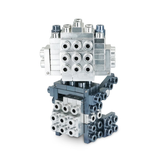 Metomics Wild Animal 71-Piece building set in silver and charcoal black, showing stacked modular blocks with connector ports assembled into a robot-like structu