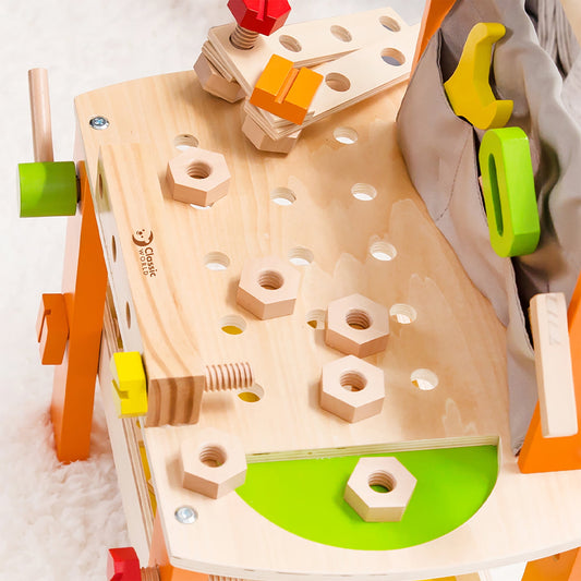 Wooden tool bench with colorful orange, green, and yellow components, wooden hexagonal nuts, and colorful blocks for pretend play building activities