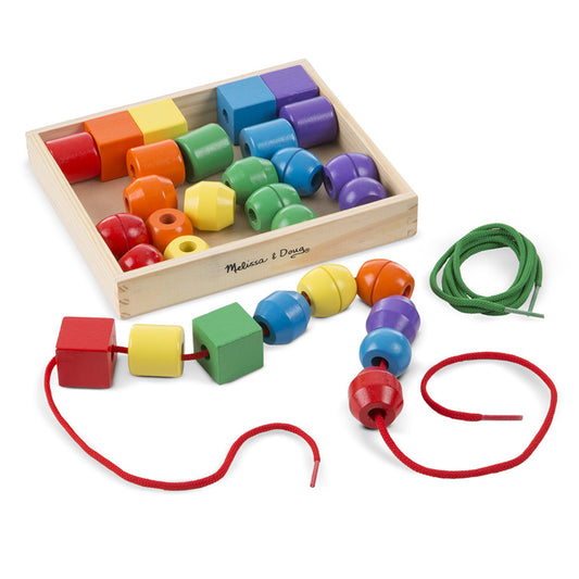 Melissa & Doug Primary Lacing Beads set with wooden box containing colorful cylindrical and cube beads in red, orange, yellow, green, blue, and purple, plus thr
