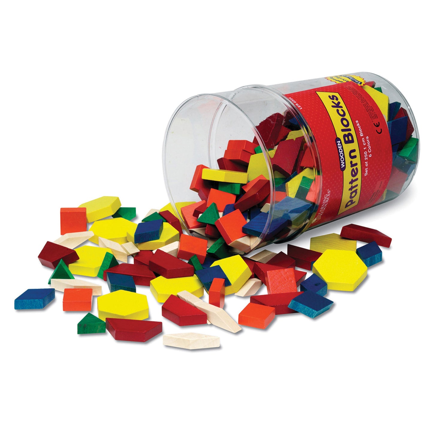 Clear plastic cylinder tipped over spilling multicolored wooden pattern blocks in red, yellow, green, blue, orange, and natural wood onto white surface