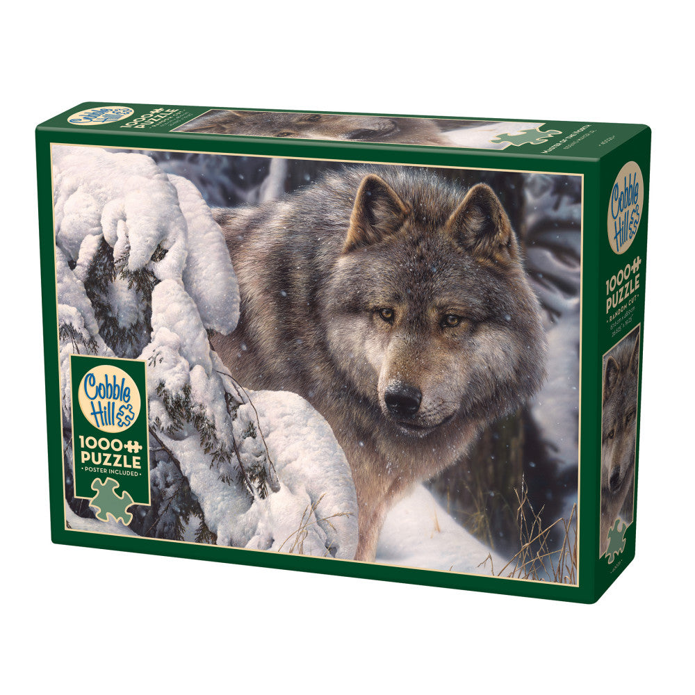 Cobble Hill 1000-piece jigsaw puzzle box featuring a gray wolf in snowy landscape with frost-covered evergreen branches