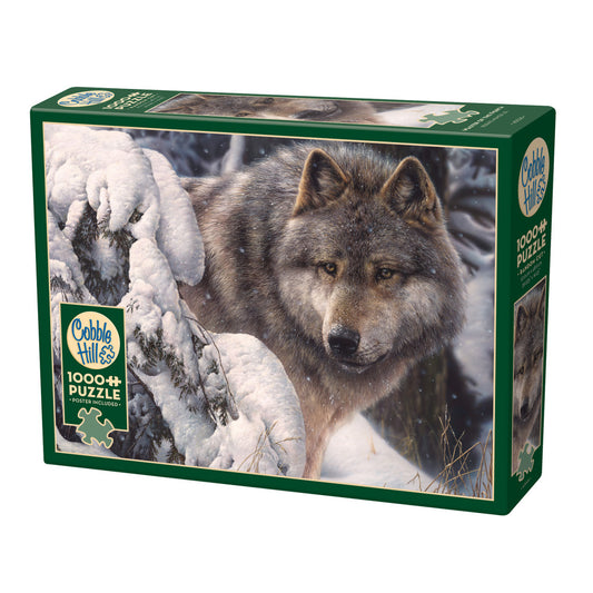 Cobble Hill 1000-piece jigsaw puzzle box featuring a gray wolf in snowy landscape with frost-covered evergreen branches