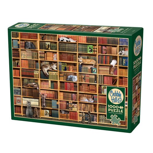 Cobble Hill 1000-piece puzzle box featuring illustrated library shelves filled with colorful books and cats lounging among them