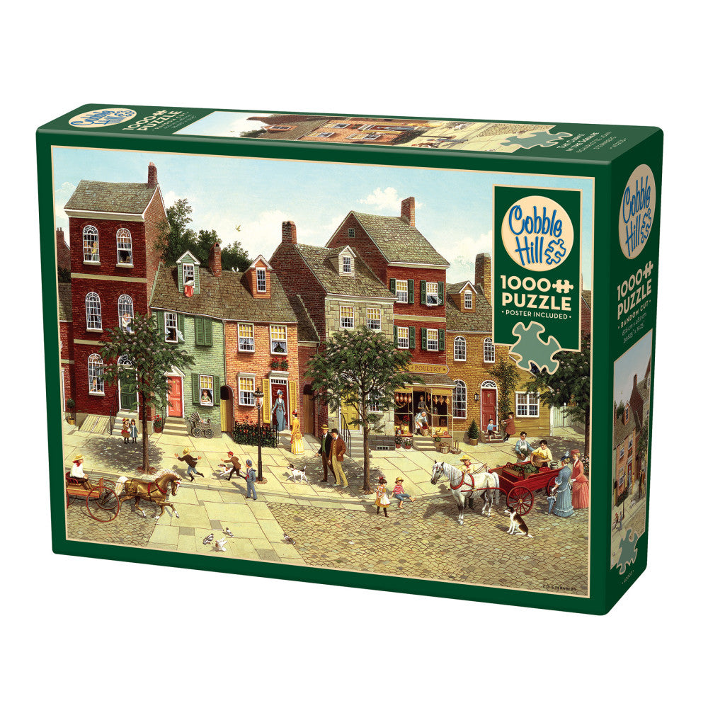 Cobble Hill 1000 piece puzzle box featuring a detailed illustration of a historic village street scene with colonial-style buildings, people, horse-drawn carts,