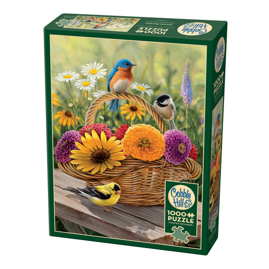 Cobble Hill 1000+ piece jigsaw puzzle box featuring illustrated birds and colorful flowers in a wicker basket on a wooden surface