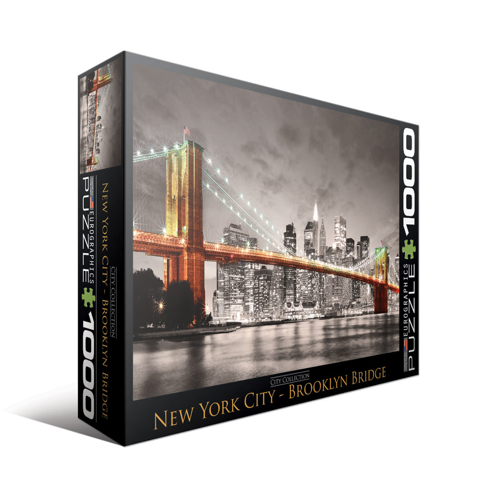 1000-piece jigsaw puzzle box featuring illuminated Brooklyn Bridge spanning New York City skyline at night with reflective water
