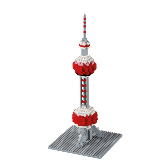 Pixel-art style building set model of a red and white tower with striped antenna on gray base plate