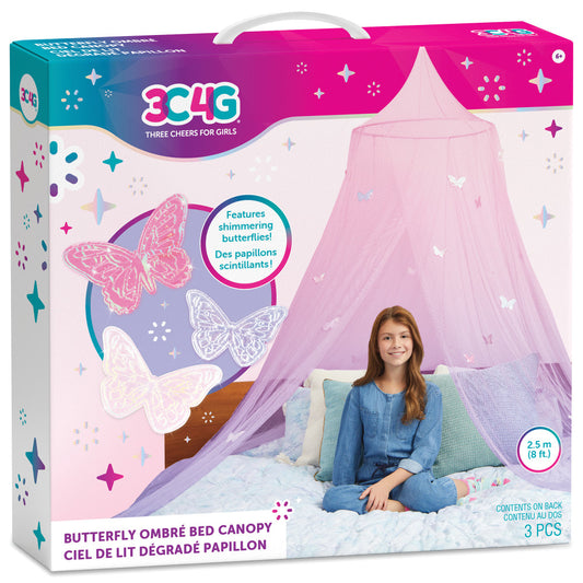 Pink and purple ombre bed canopy with shimmering butterfly details, modeled by a child sitting on a bed with pillows