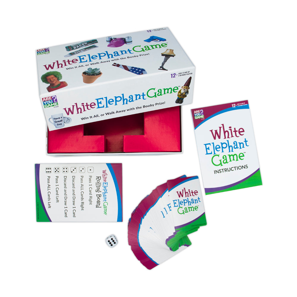 White Elephant Game board game box open showing pink interior, instruction booklet, dice, and fanned cards displayed on white background