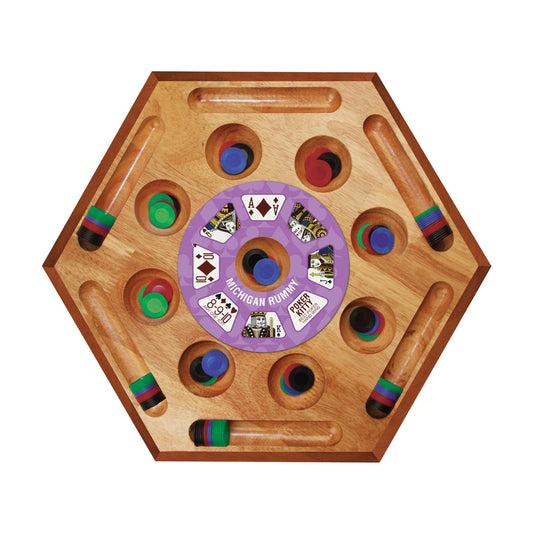 Hexagonal wooden board game with purple center wheel labeled Michigan Rummy, colorful wooden pegs in cup holders, and wooden cue sticks with striped handles