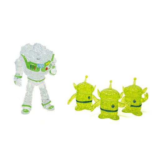 Clear and lime-green transparent 3D crystal puzzle pieces including Buzz Lightyear figure and three alien characters on plain background