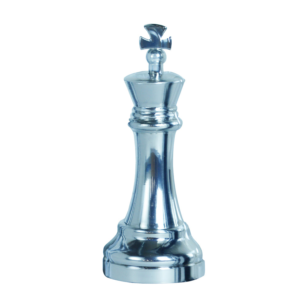 Silver metallic chess king piece puzzle on plain white background