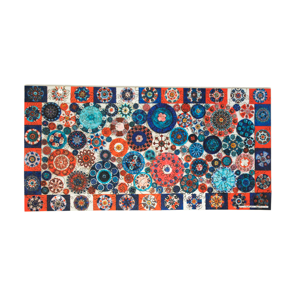 Wooden jigsaw puzzle with 309 pieces featuring a colorful geometric circles pattern in blue, orange, cream, and navy tones