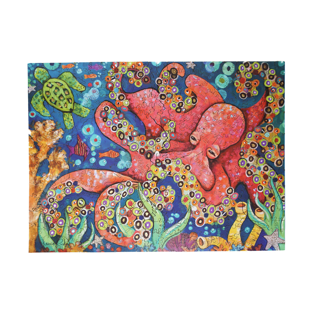 Colorful wooden jigsaw puzzle featuring a vibrant underwater scene with red octopus, sea turtle, coral, and decorative circular patterns on blue background