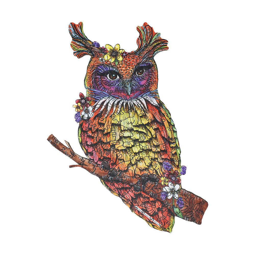 Colorful illustrated owl with purple and orange plumage, yellow belly, decorative flowers, and intricate patterns perched on a brown branch against white backgr