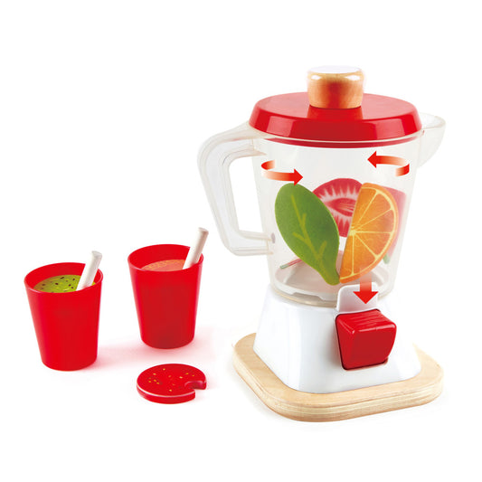 Wooden smoothie blender playset with red and white blender base, red lid, two red cups with straws, fruit slices, and wooden base