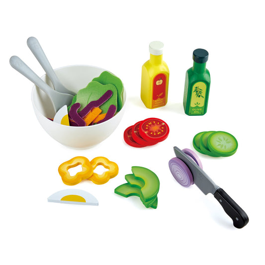 Hape Healthy Salad wooden kitchen playset with white bowl, gray utensils, and colorful play food pieces including vegetables, bottles of oil and vinegar, and a