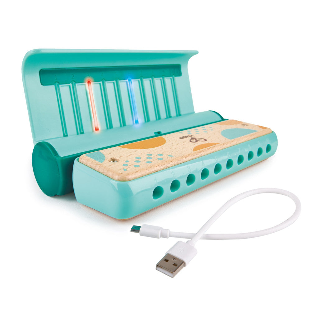 Turquoise learn-with-lights harmonica with wooden top panel, light-up keys, and USB charging cable included