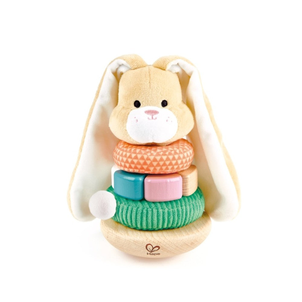 Cream-colored wooden bunny stacker toy with long ears, smiling face, and stacking rings in orange, teal, pink, and green with a white ball attachment