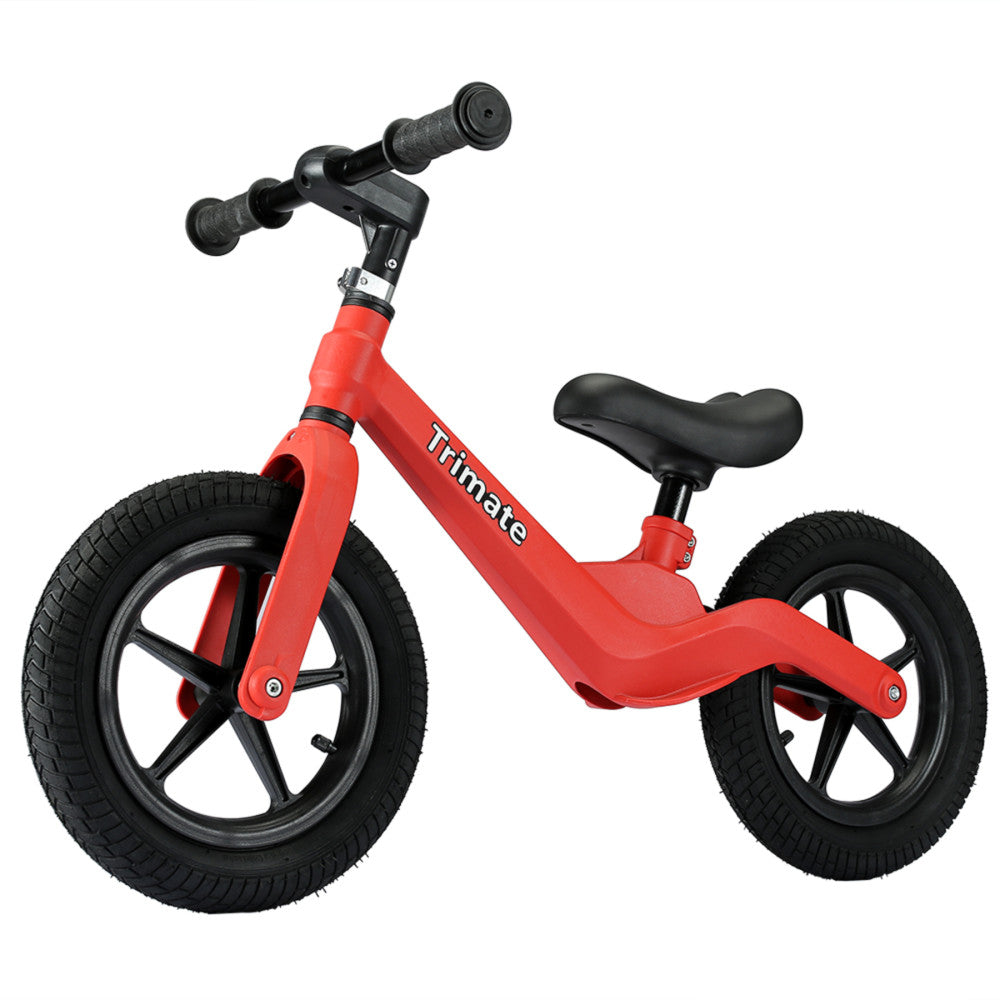 Red balance bike with black handlebars, seat, and 12-inch tires on plain white background