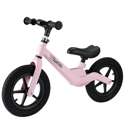 Pink balance bike with black handlebars, black saddle, and black pneumatic tires on plain background