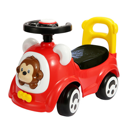 Red ride-on car with monkey face design, yellow handles, black steering wheel, and black wheels on plain background