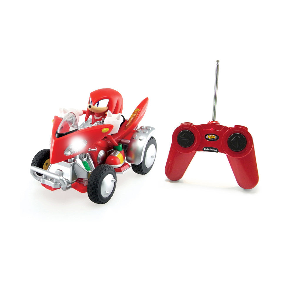 Red remote control ATV with Knuckles character figure on top, shown with red radio control transmitter featuring antenna