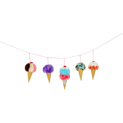 Five colorful pom pom ice cream cone ornaments hanging from a pink string against a white background
