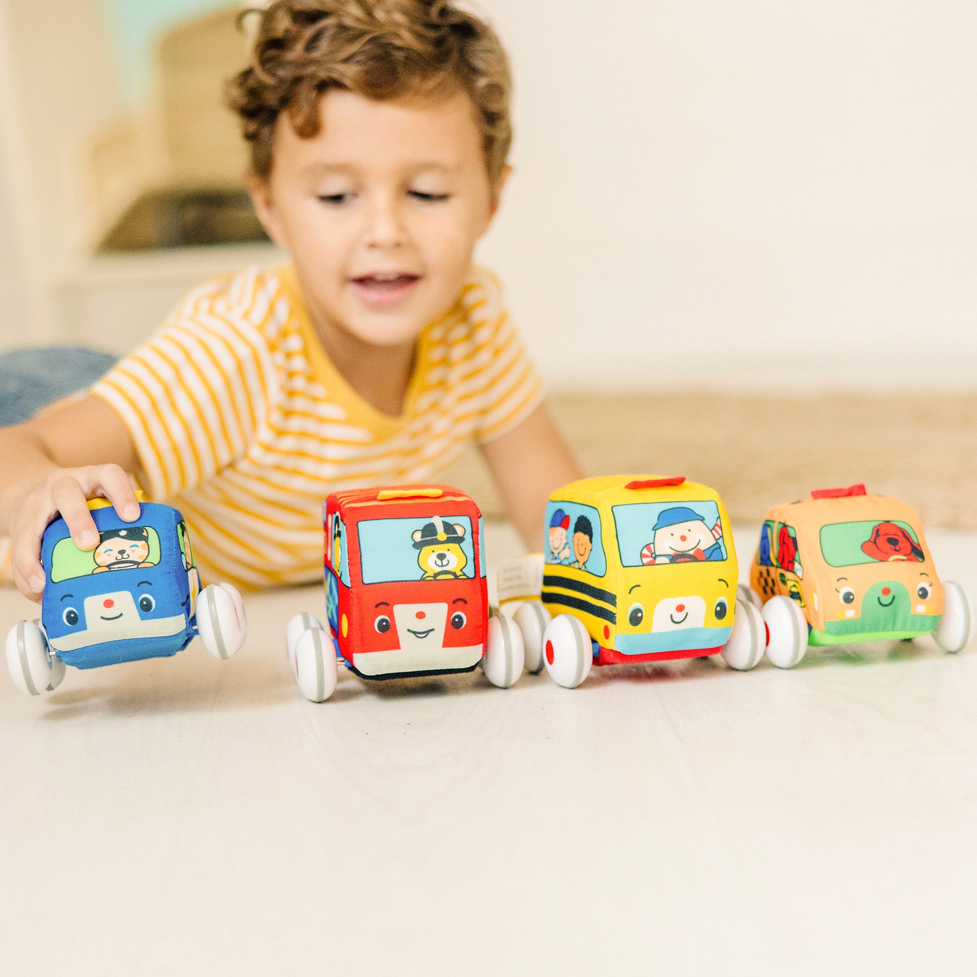 Melissa & Doug K's Kids Pull-Back Vehicle Set with four colorful soft toy cars in blue, red, yellow, and green