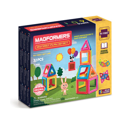 Magformers My First Play 32 Set box showing colorful magnetic building pieces, assembled structures including a tower, and a character with balloons on a grassy