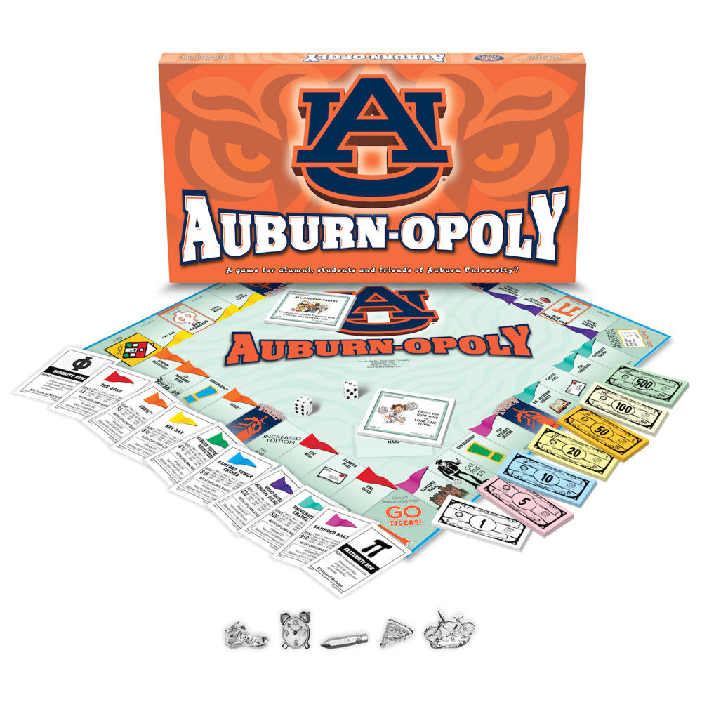 Auburn-opoly board game box and contents displayed, including game board, player pieces, dice, colored money, and instruction cards themed with Auburn Universit