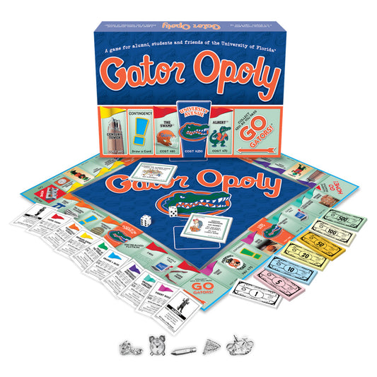 Gatoropoly board game with blue game board featuring Florida Gators logo, box, property cards, play money, game pieces, and die displayed