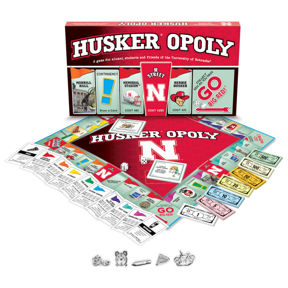 Husker Opoly board game with red game board, property cards, play money in denominations from $1 to $500, dice, and metal game pieces displayed