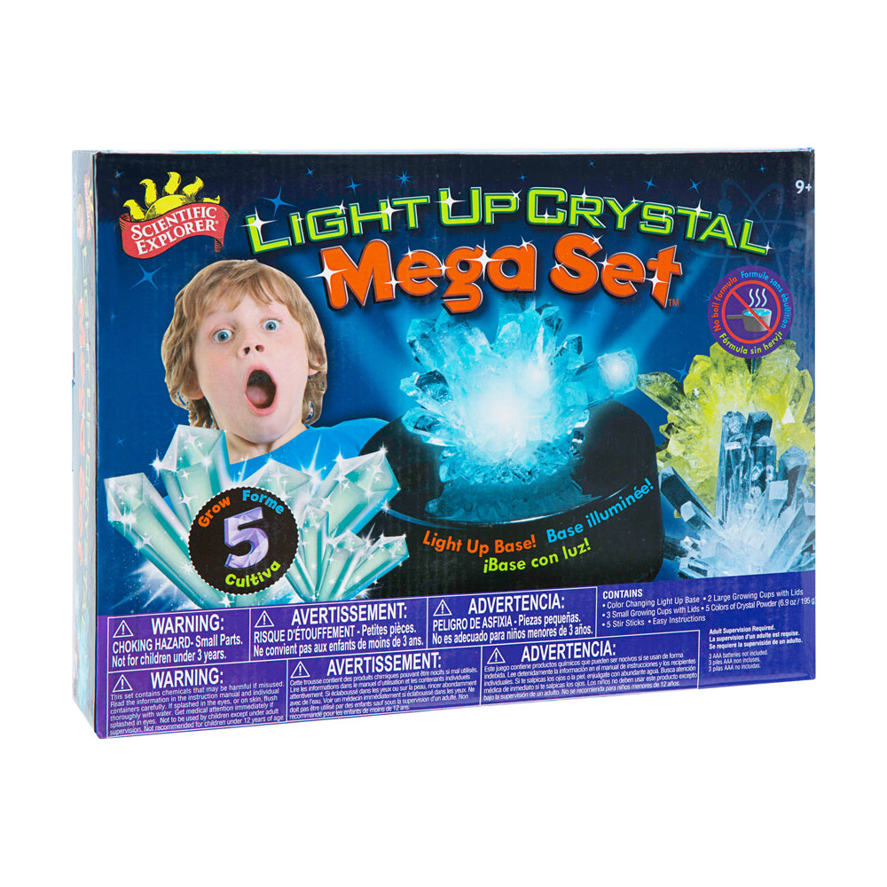 Scientific Explorer Light Up Crystal Mega Set box showing a child's surprised expression next to glowing blue crystals, with illuminated crystal formations disp