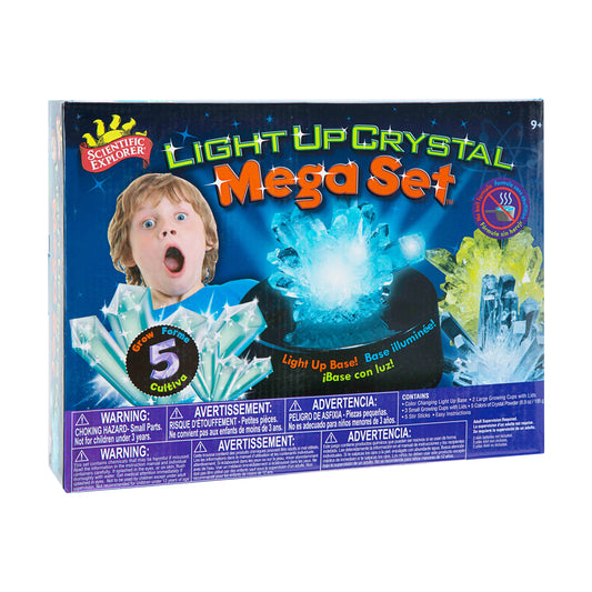 Scientific Explorer Light Up Crystal Mega Set box showing a child's surprised expression next to glowing blue crystals, with illuminated crystal formations disp