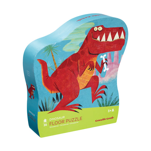 Crocodile Creek Dinosaur Floor Puzzle box featuring a red T-Rex with big eyes and teeth holding an ice cream cone on a blue tropical background, 36 pieces, ages