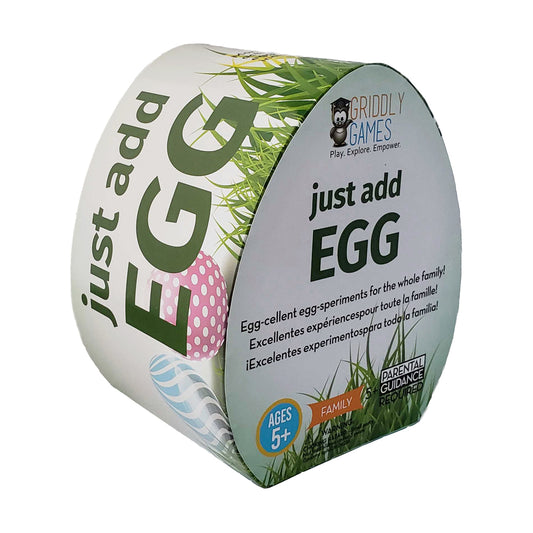 Griddly Games Just Add Egg egg-shaped packaging with green text, pink polka dot egg illustration, and grass design; ages 5+