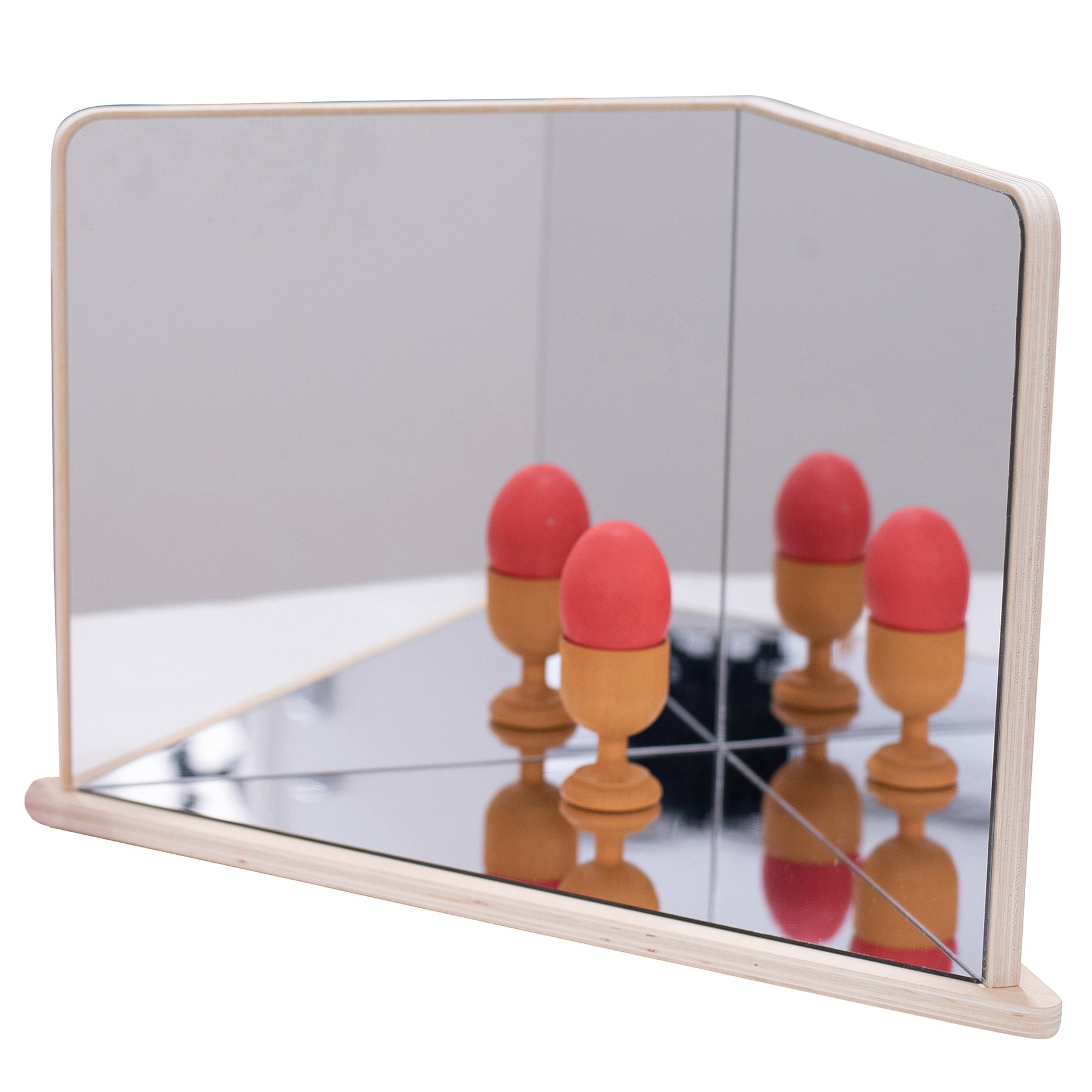 Wooden 4-way mirror with natural frame showing reflections of red and tan egg-shaped objects on mirrored surface