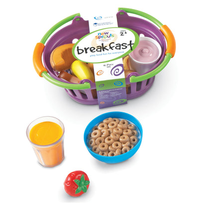 New Sprouts Breakfast play food set with purple and green basket containing toy food items, orange juice cup, bowl of cereal, and red tomato