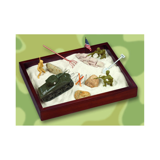 Wooden sandbox with white sand containing miniature military figurines, tank, American flag, rocks, and play accessories on green background