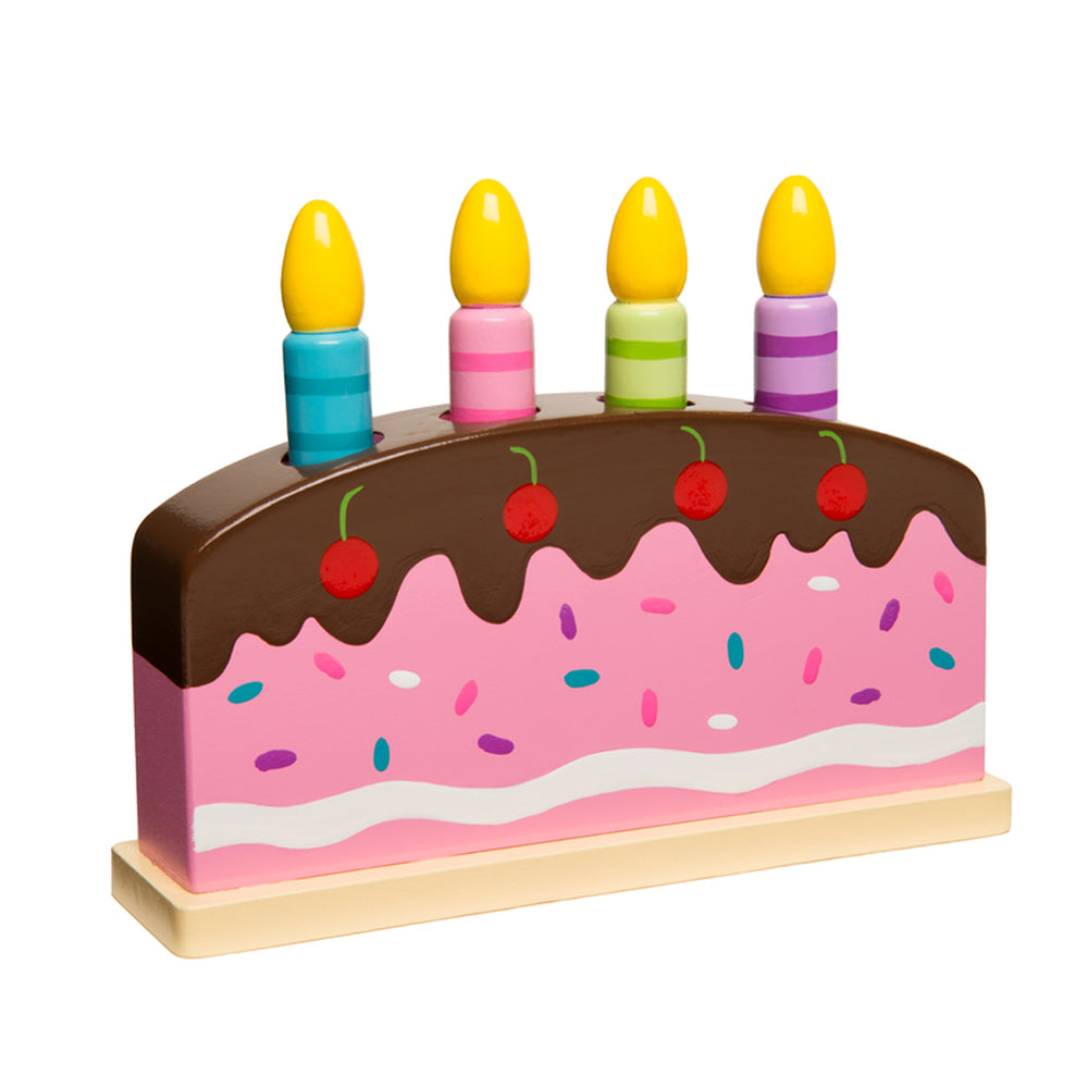 Wooden pop-up birthday cake toy with brown chocolate frosting top, pink cake layer with colorful sprinkles, four yellow candles in colored holders, and red cher