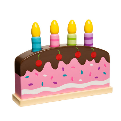 Wooden pop-up birthday cake toy with brown chocolate frosting top, pink cake layer with colorful sprinkles, four yellow candles in colored holders, and red cher